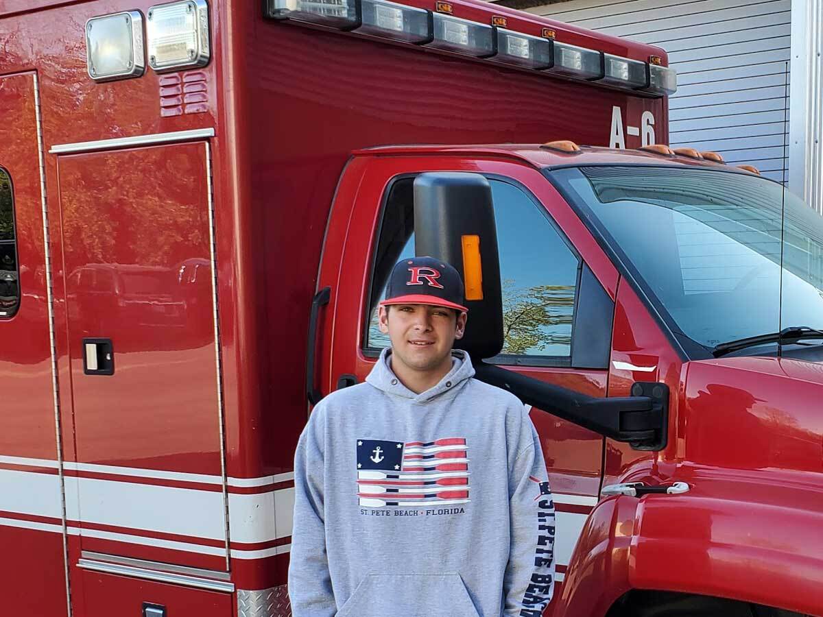 standing in front of the school's training ambulance