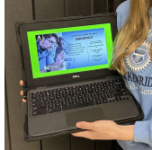 Girl holding a Chromebook